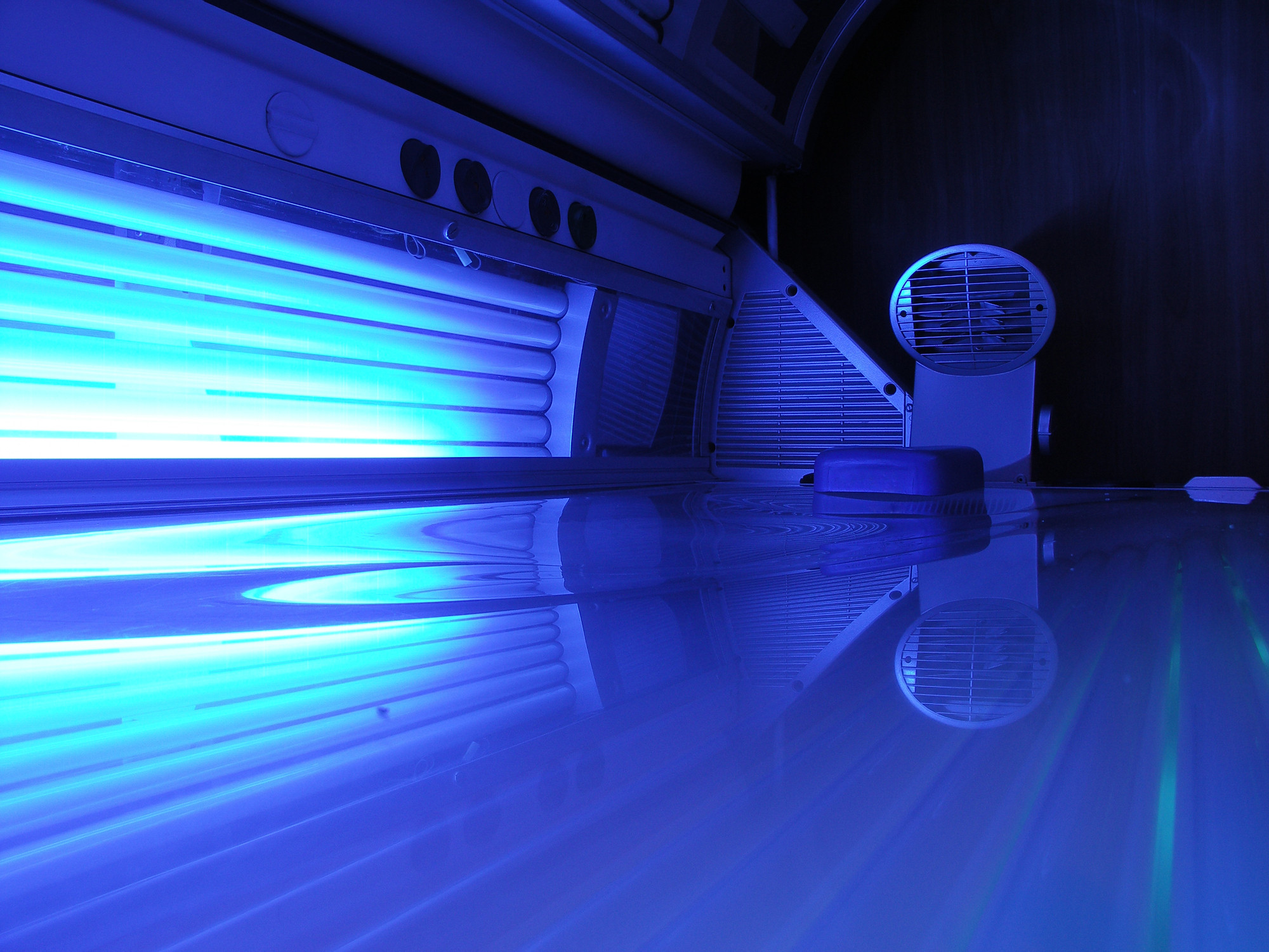 A person tanning nude in a tanning bed