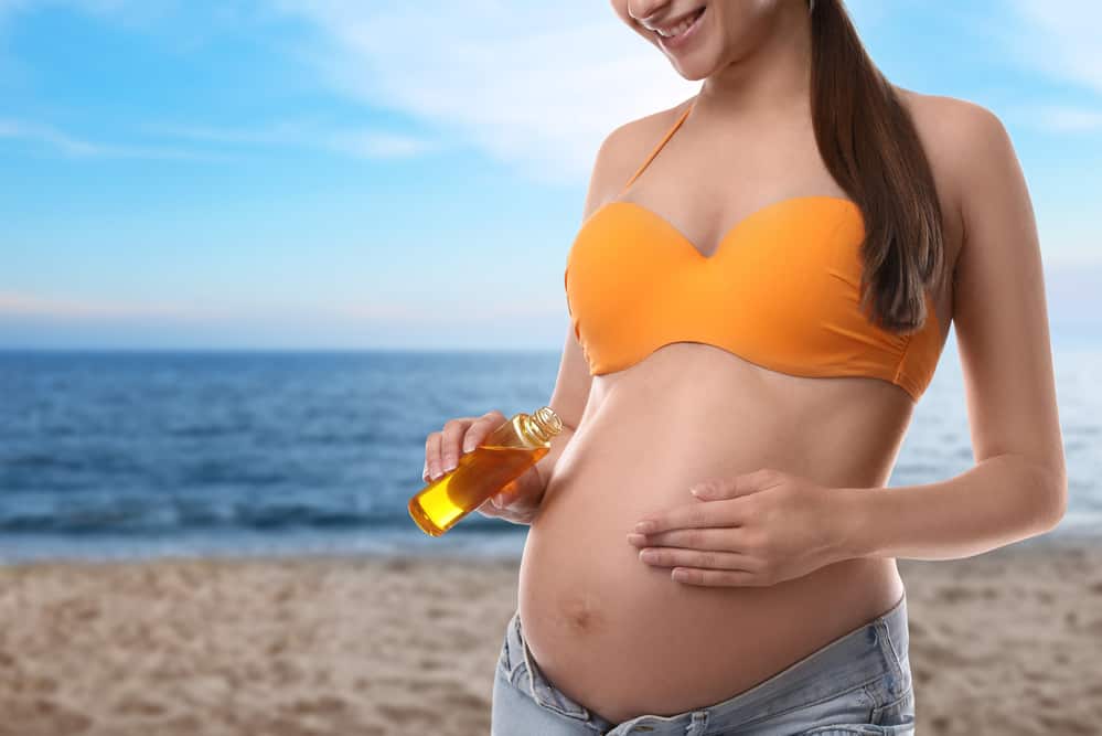 A woman applying a pregnancy safe self tanner on her skin